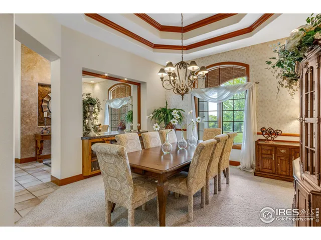 a view of a dining room with furniture a chandelier and wooden floor