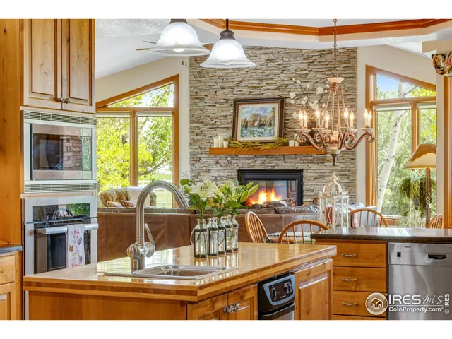 a kitchen with a stove a sink and cabinets