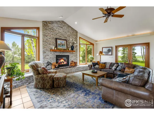 a living room with furniture a window and a fireplace