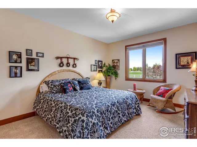 a bedroom with a bed next to a window