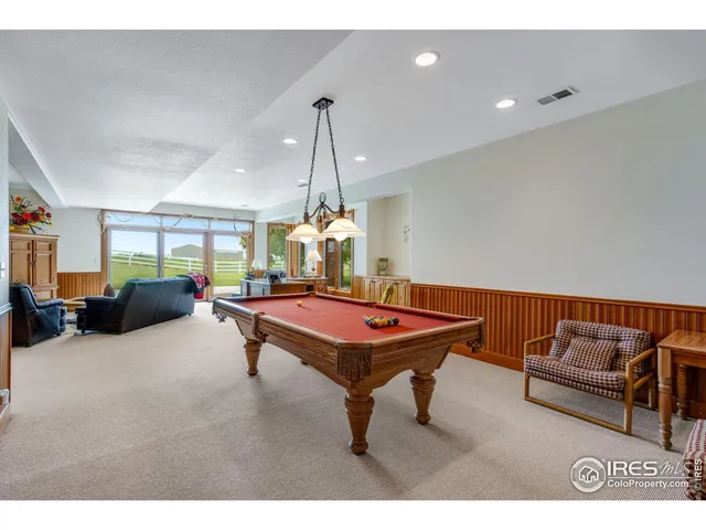 a living room with furniture a table and a chandelier
