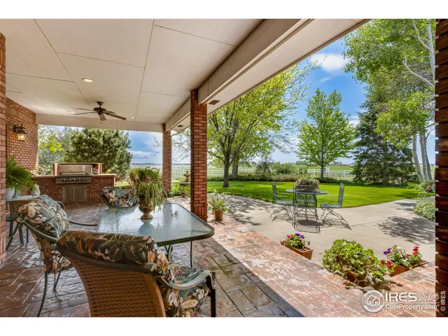 a view of a patio with a table and chairs