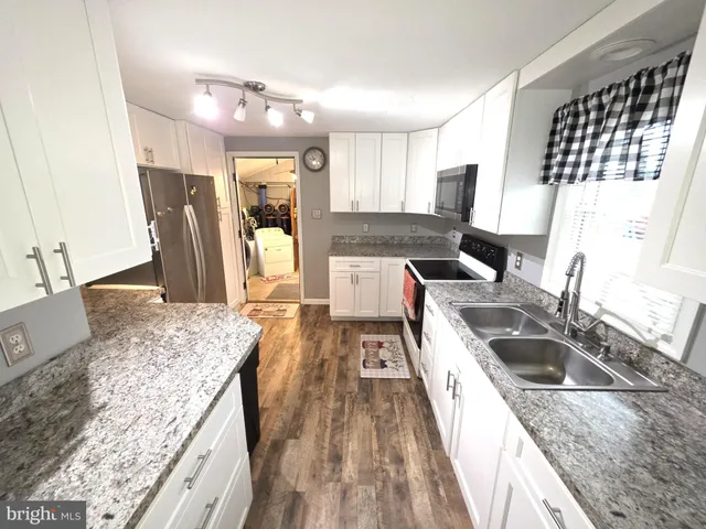 a kitchen with a stove and a sink