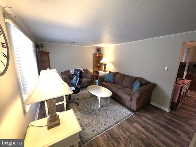 a living room with couches and a table with wooden floor