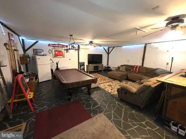 a living room with furniture a air conditioner vent and a rug