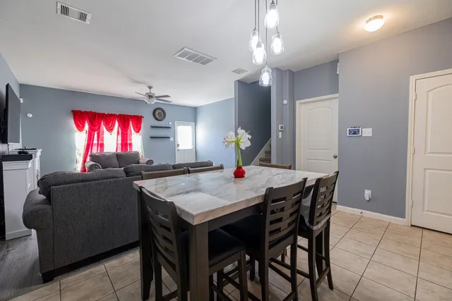 a view of a dining room with furniture and chandelier