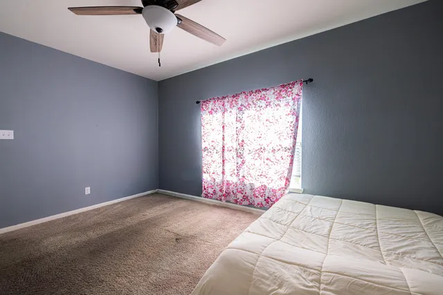 a bedroom with a bed and a window