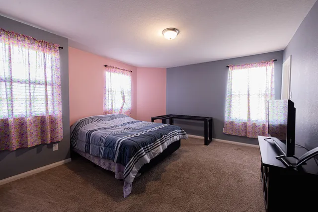 a bedroom with a bed and a television