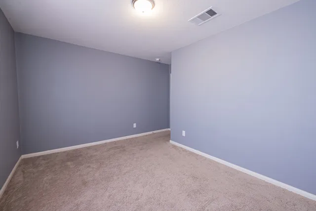 a room with a bed and wooden floor