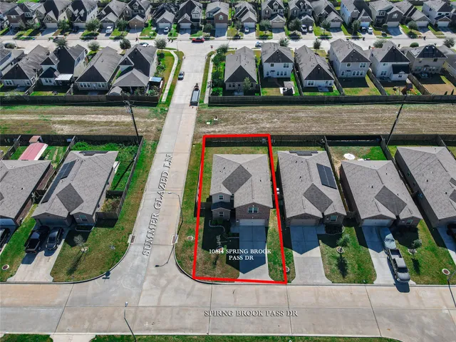 an aerial view of multiple houses with yard