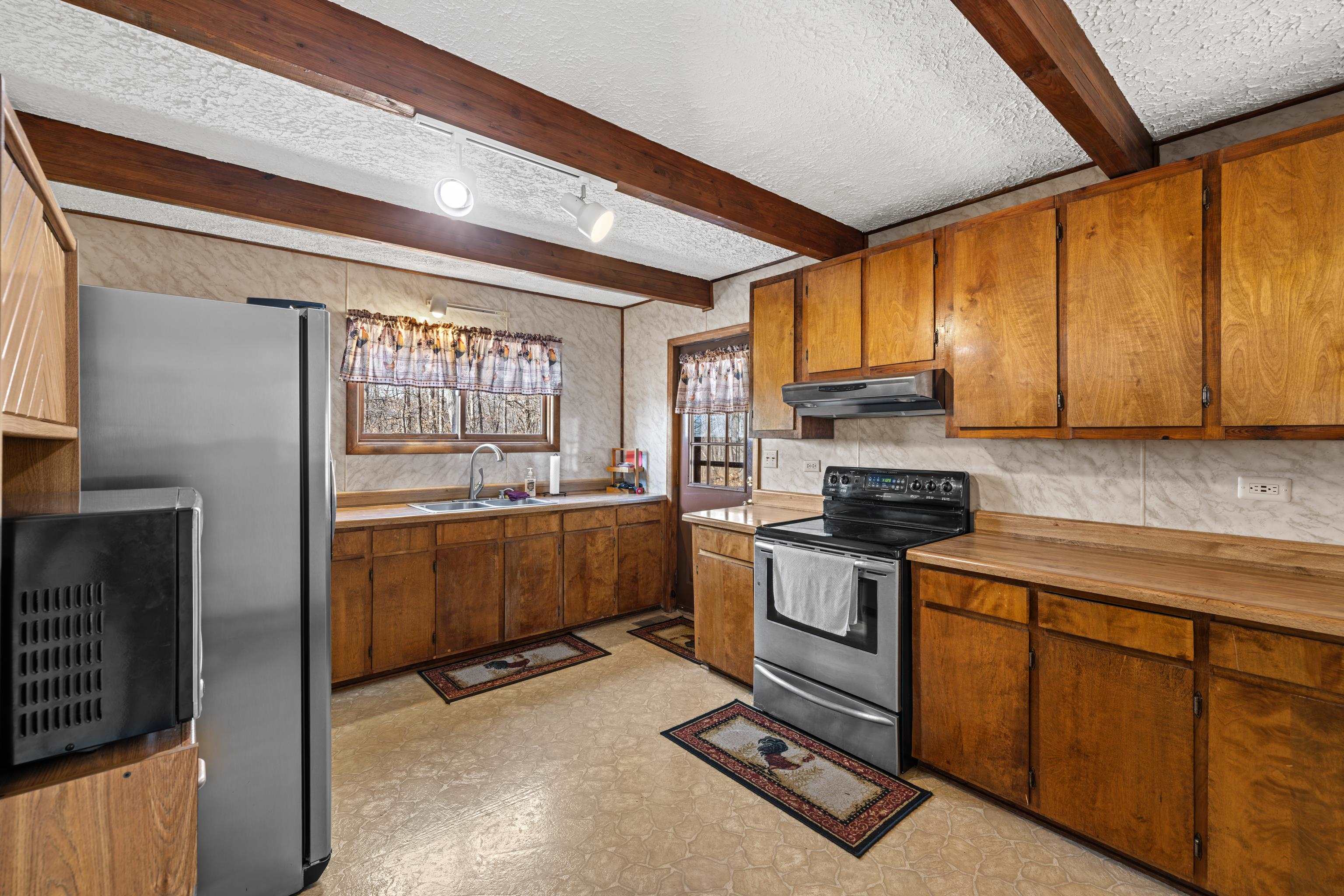 7386 Apple Ridge Drive Timberville, VA 22853 - Photo 22 of 62 a kitchen with stainless steel appliances granite countertop a stove a sink and a refrigerator