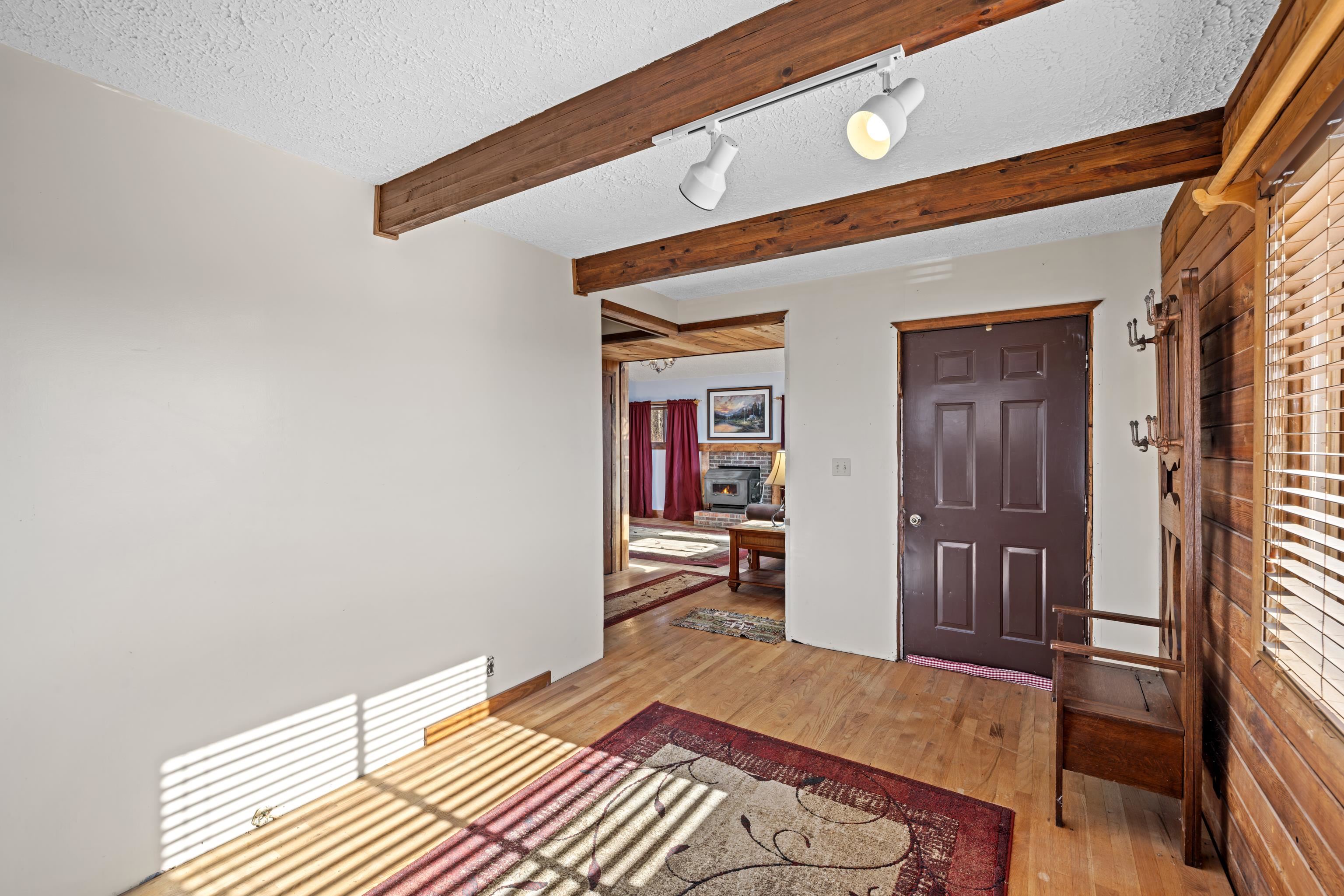 7386 Apple Ridge Drive Timberville, VA 22853 - Photo 25 of 62 a bedroom with a bed and a chandelier