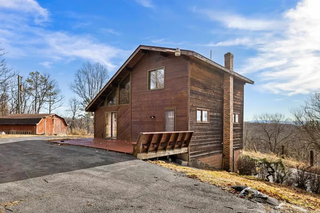 a view of a house with wooden fence