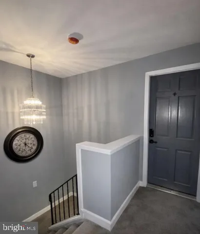a view of a hallway with washer and dryer