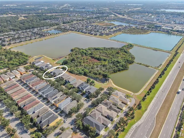 an aerial view of residential houses with outdoor space