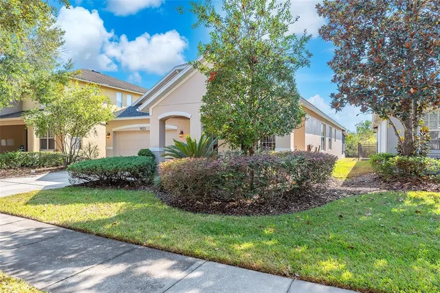 a view of a house with a yard and plants