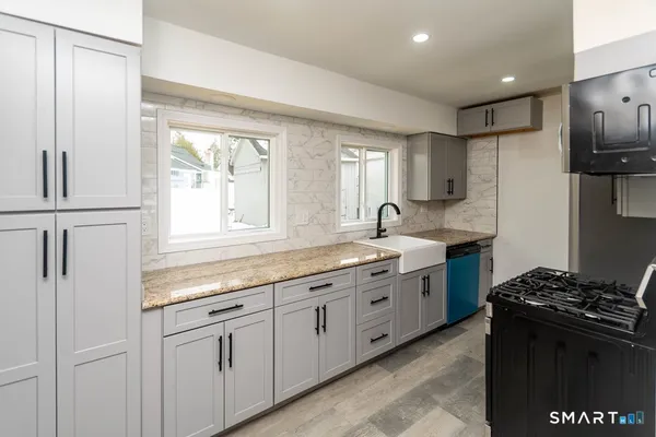 a kitchen with sink cabinets and window