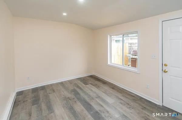 wooden floor in an empty room with a window