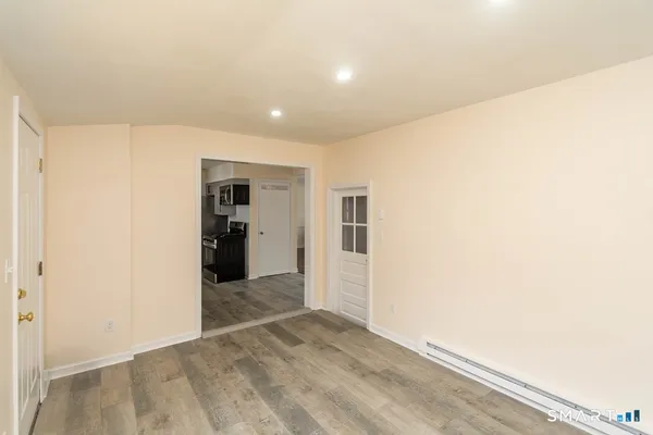 a view of a hallway with wooden shelves
