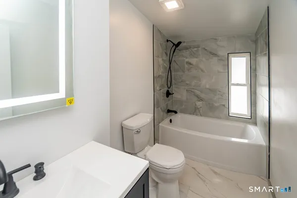 a bathroom with a sink a toilet and bathtub