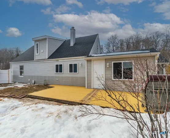 a view of a house with pool and sitting area