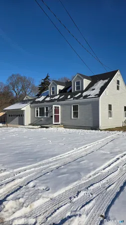 a front view of a house with a road
