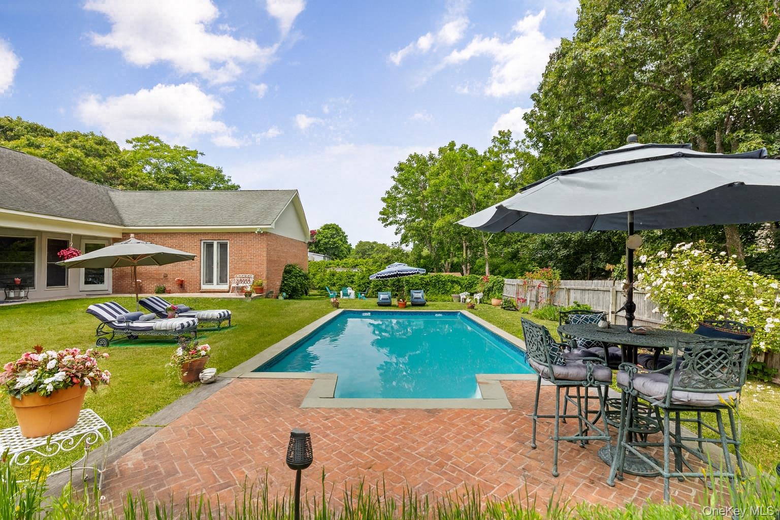 2 Sunset Road Sag Harbor, NY 11963 - Photo 17 of 21 View of pool featuring a patio area, a fenced backyard, outdoor dining area, and view of scattered trees