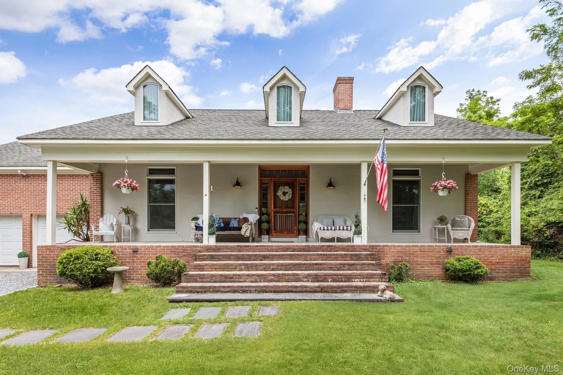 2 Sunset Road Sag Harbor, NY 11963 - Photo 18 of 21 a front view of a house with garden and porch