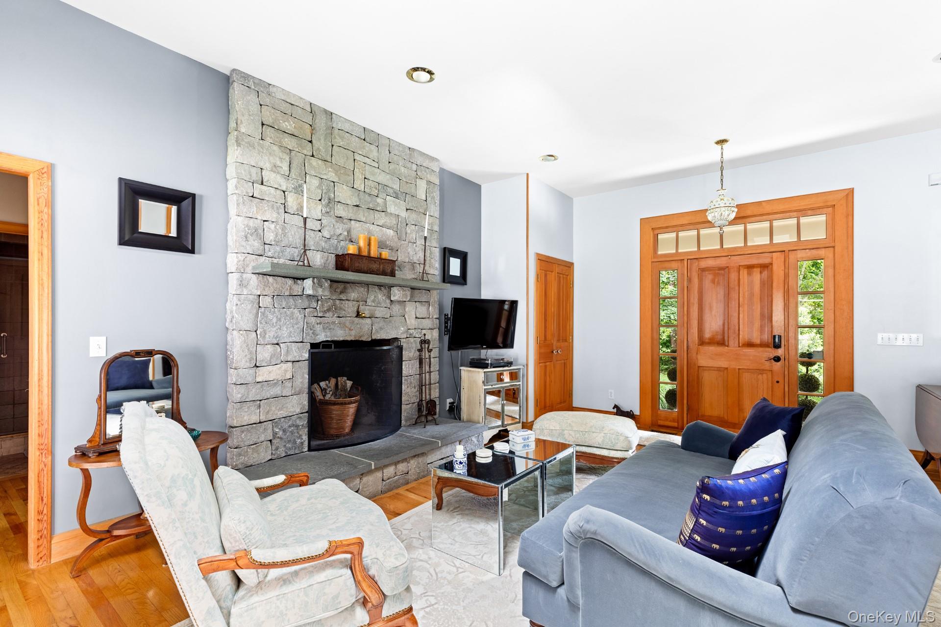2 Sunset Road Sag Harbor, NY 11963 - Photo 7 of 21 a living room with furniture fireplace and a flat screen tv
