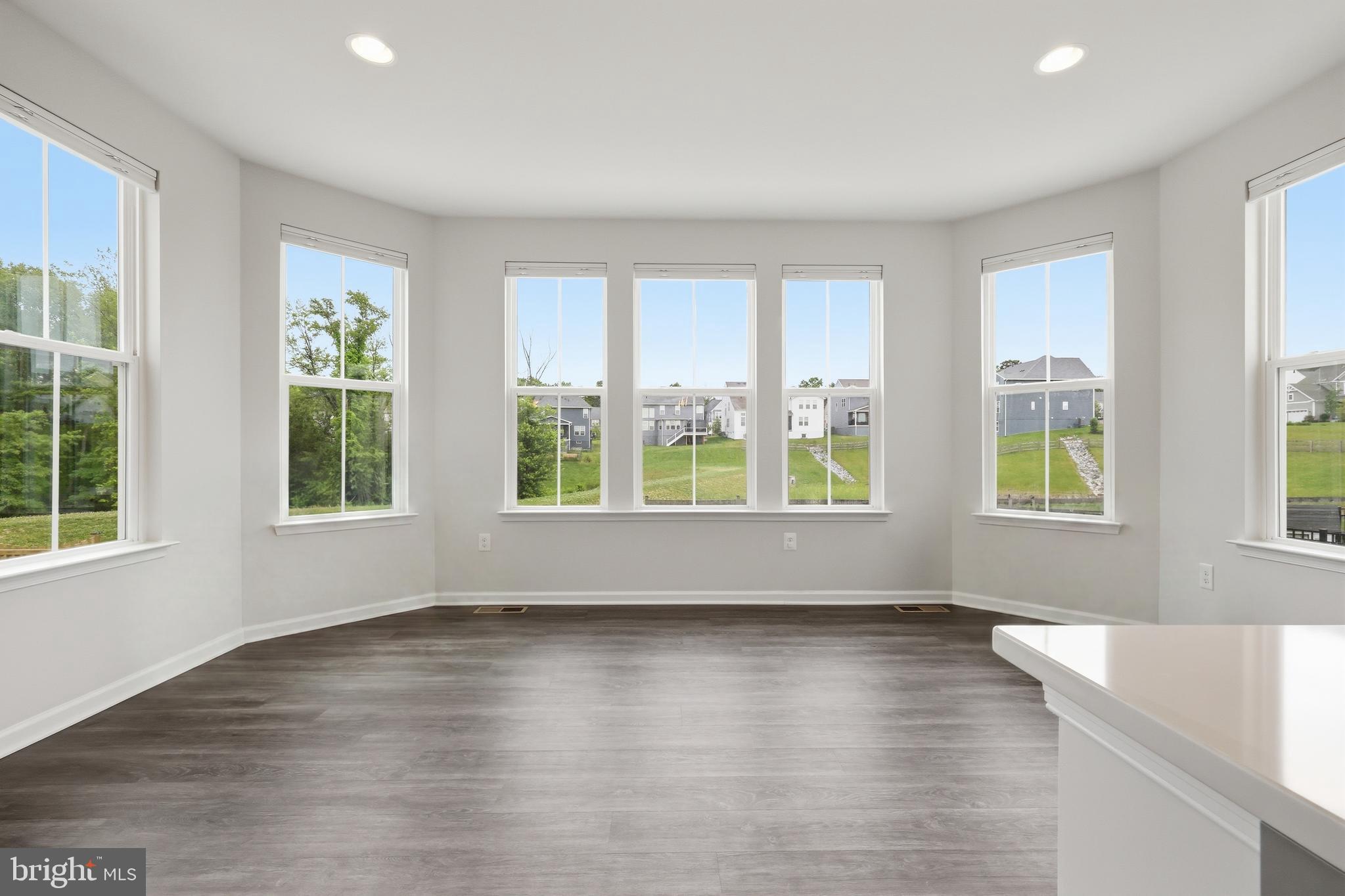 5707 Hawk Ridge Road Frederick, MD 21704 - Photo 18 of 109 a view of an empty room with wooden floor and a window