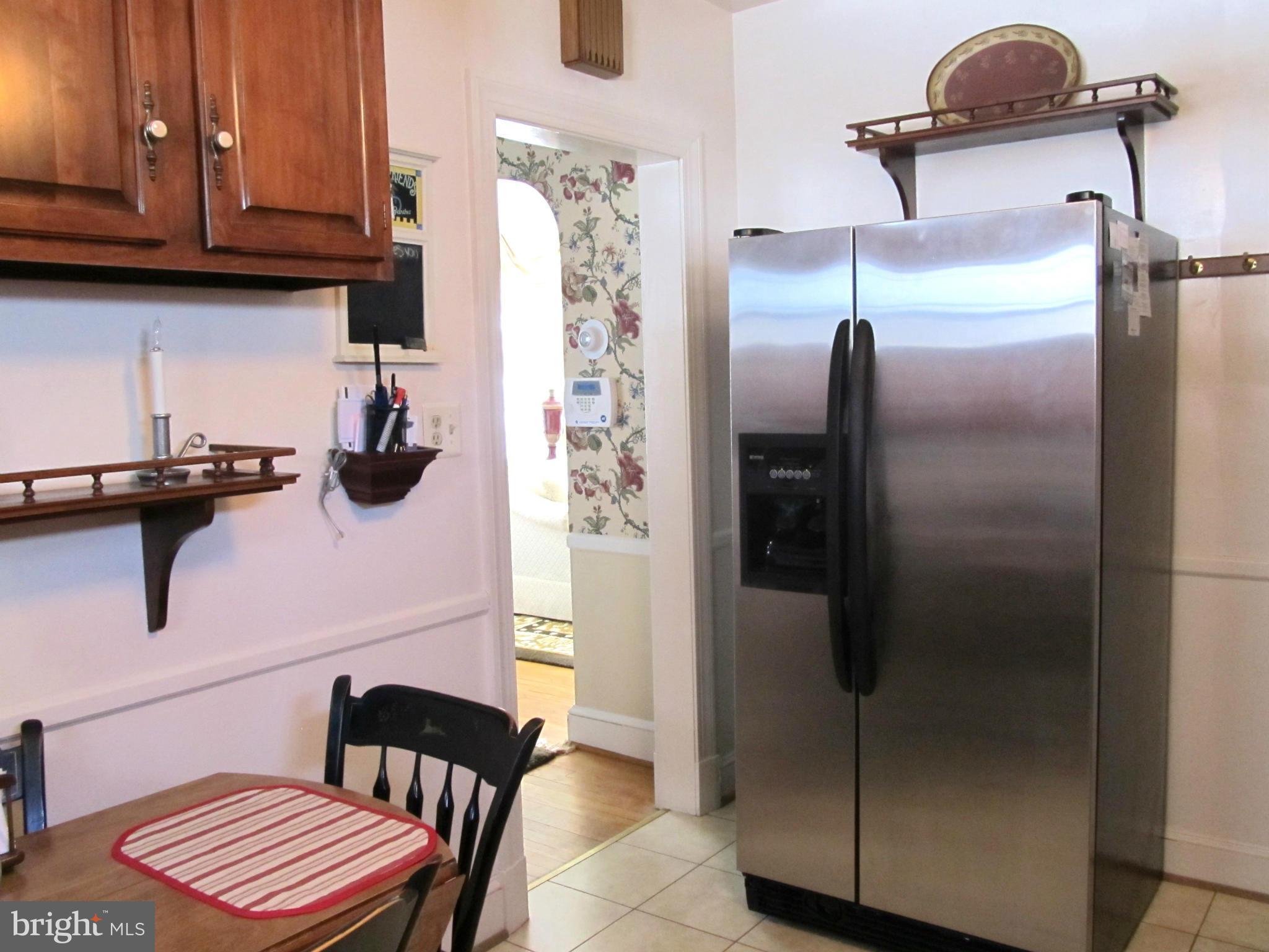 422 Forest View Road Linthicum, MD 21090 - Photo 11 of 25 a kitchen with a refrigerator and cabinets