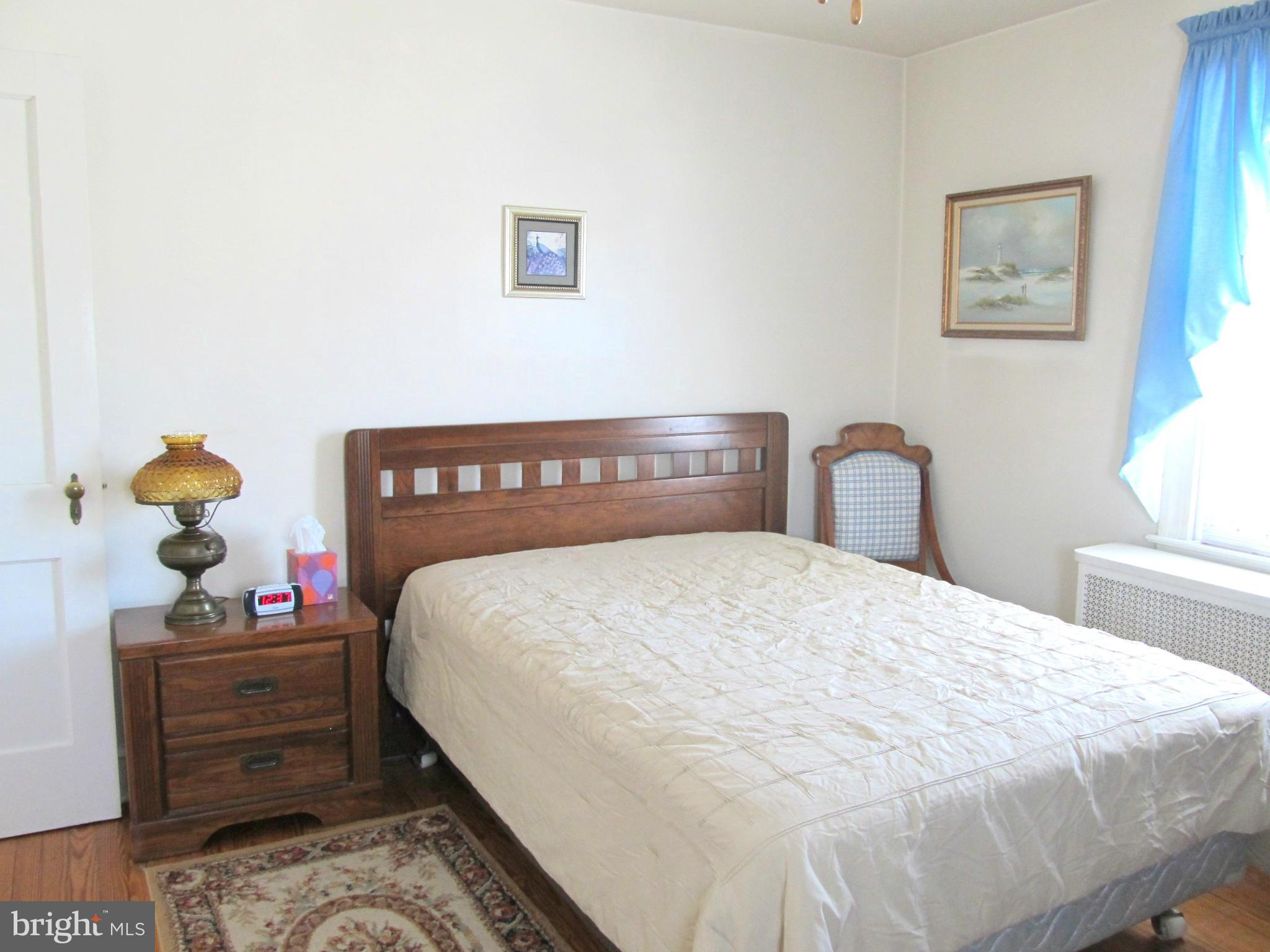 422 Forest View Road Linthicum, MD 21090 - Photo 13 of 25 a bedroom with a bed and wall painting