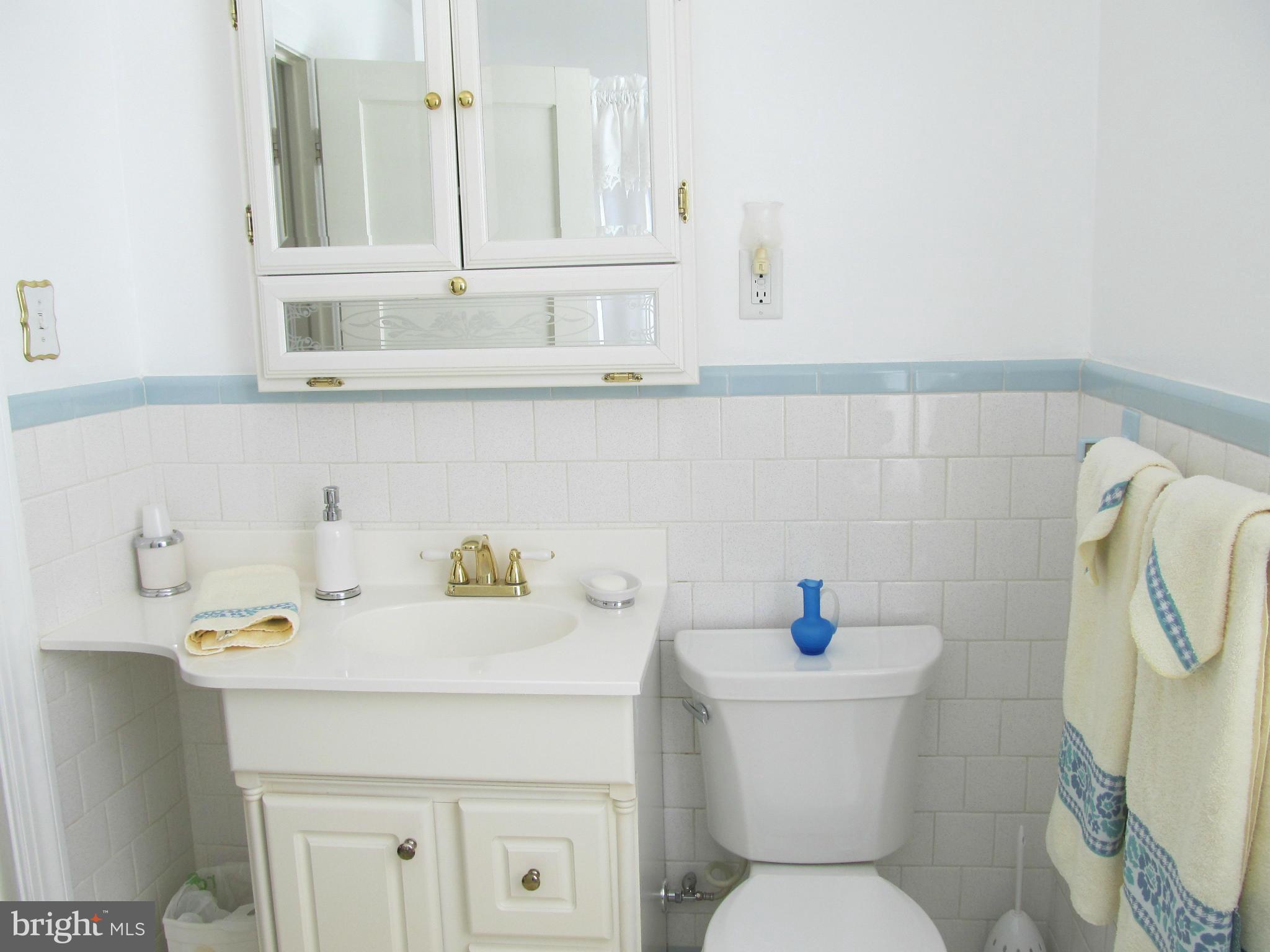 422 Forest View Road Linthicum, MD 21090 - Photo 16 of 25 a bathroom with a sink a toilet and a mirror