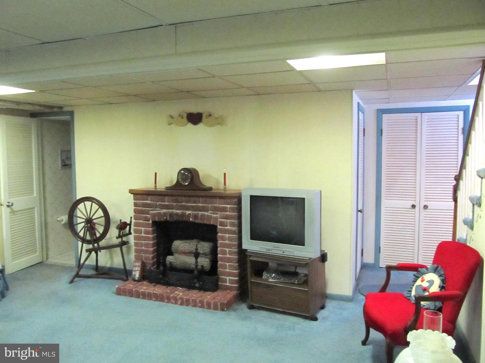 422 Forest View Road Linthicum, MD 21090 - Photo 20 of 25 a living room with furniture a flat screen tv and a fireplace