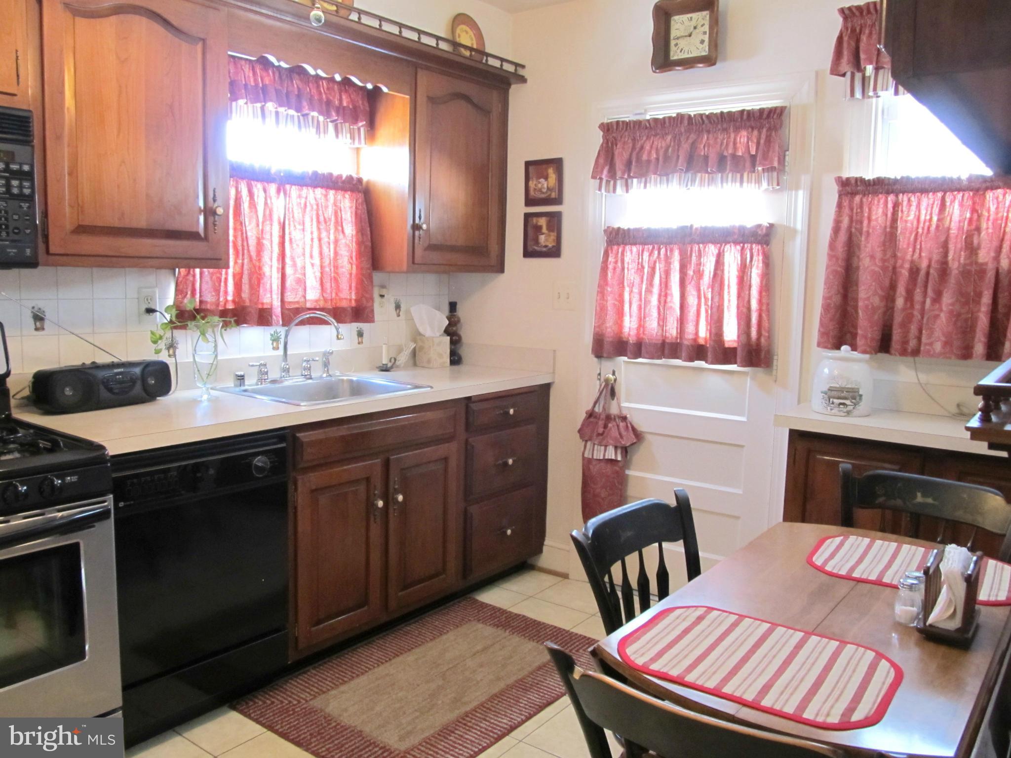 422 Forest View Road Linthicum, MD 21090 - Photo 9 of 25 a kitchen with a sink cabinets and wooden floor