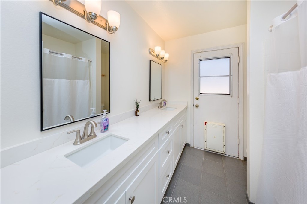 39752 Makin Avenue Palmdale, CA 93551 - Photo 13 of 15 a bathroom with double vanity and a mirror
