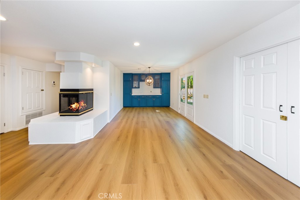 39752 Makin Avenue Palmdale, CA 93551 - Photo 5 of 15 a view of a livingroom with wooden floor and a fireplace