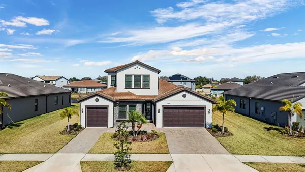 a front view of a house with a yard and garage