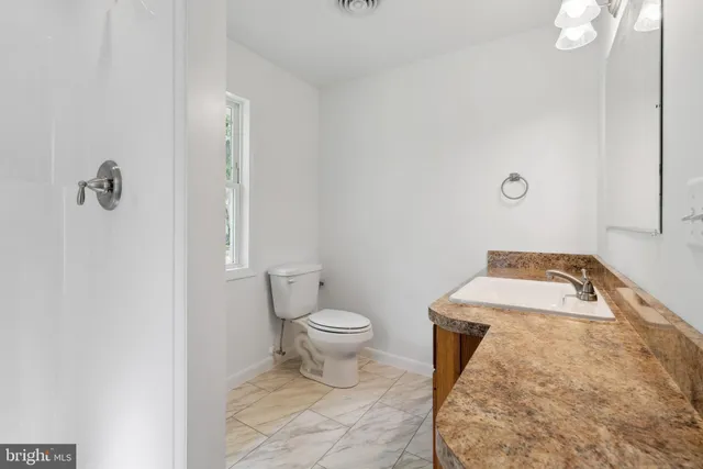 a bathroom with a toilet and a sink