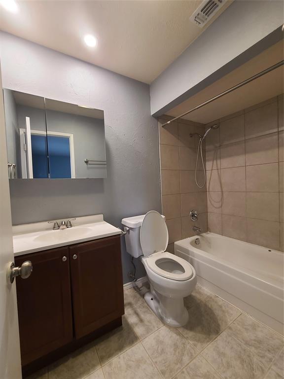 5644 Perrin Street The Colony, TX 75056 - Photo 14 of 16 Full bathroom with vanity, tile patterned flooring, tiled shower / bath combo, and toilet