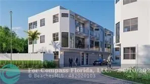 a front view of a building with garden and plants