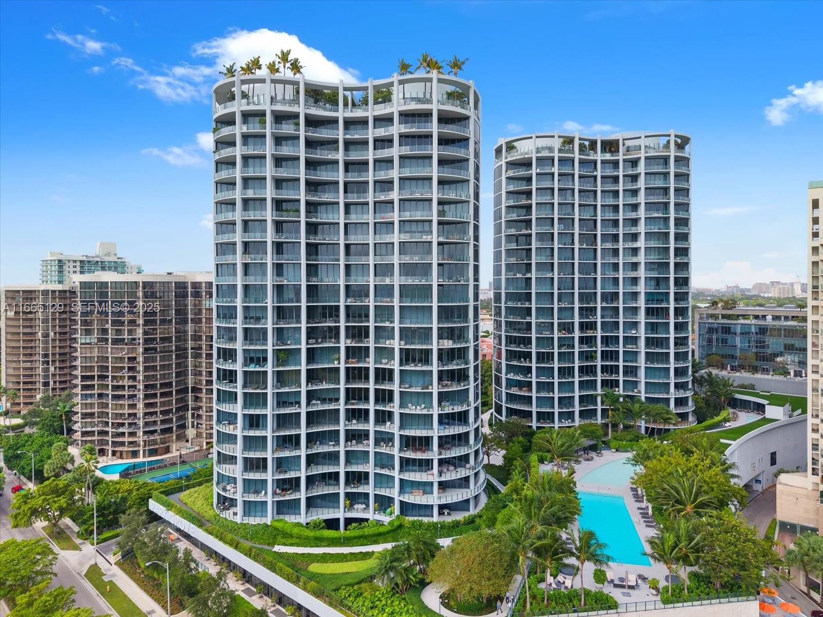 2811 South Bayshore Drive, Unit 4C Miami, FL 33133 - Photo 16 of 37 a front view of a building with a yard