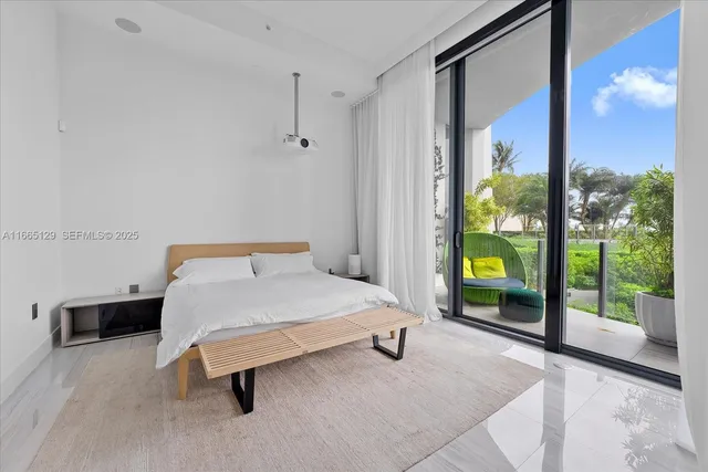a bedroom with a bed and a dresser next to a window