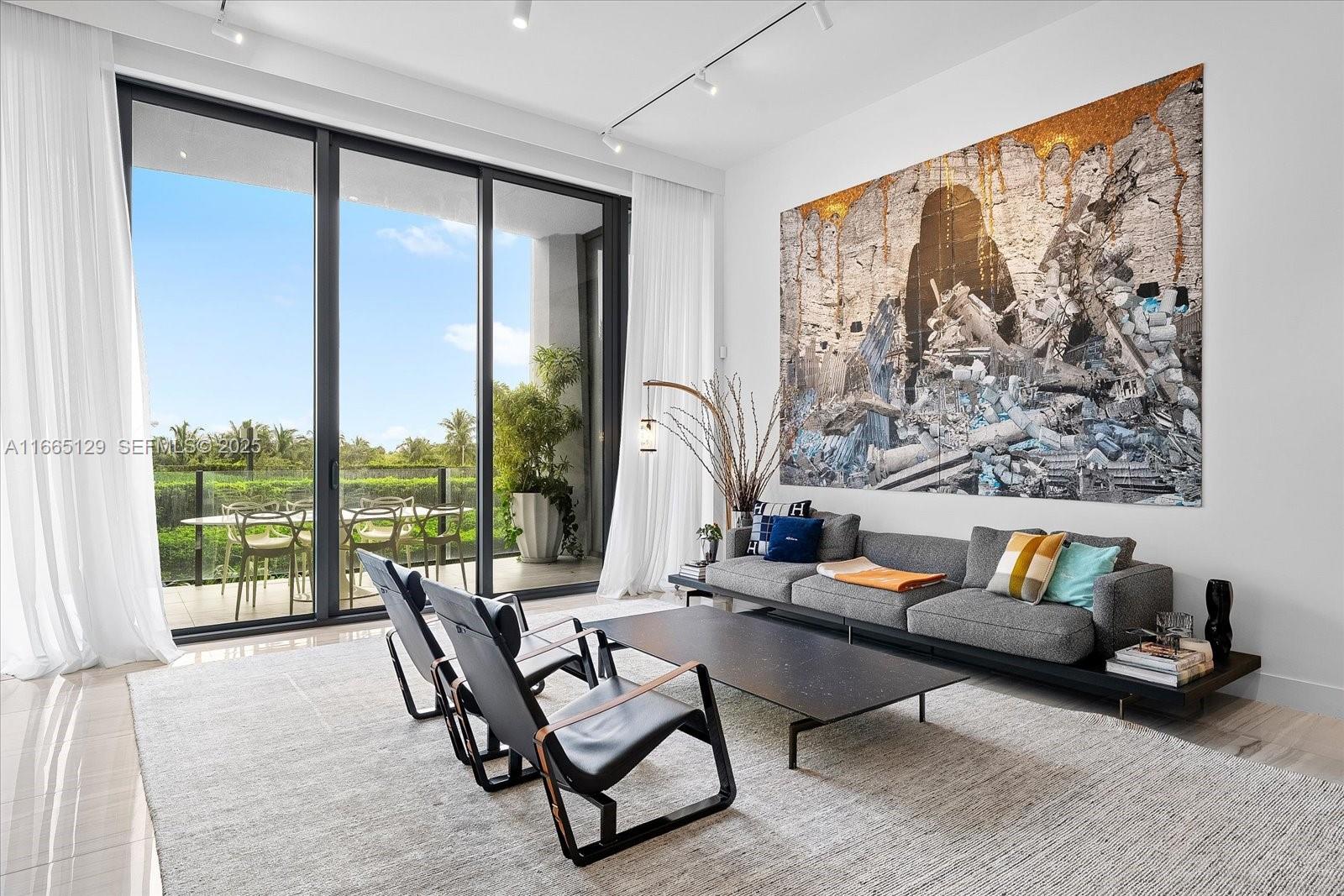 2811 South Bayshore Drive, Unit 4C Miami, FL 33133 - Photo 2 of 37 a living room with furniture and a large window