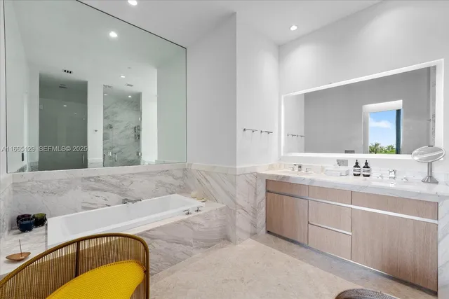 a bathroom with a tub sink and mirror