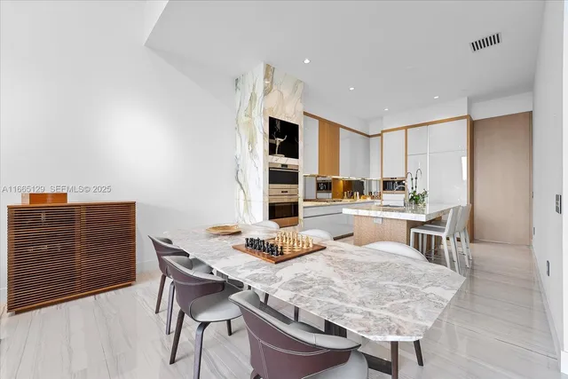 a dining room with furniture and wooden floor