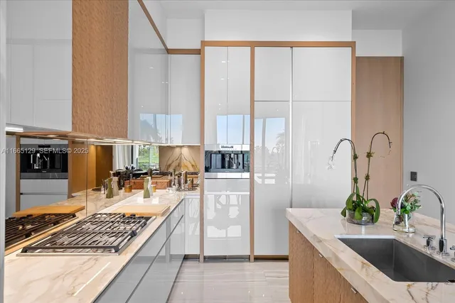 a kitchen with kitchen island granite countertop a sink stove and cabinets