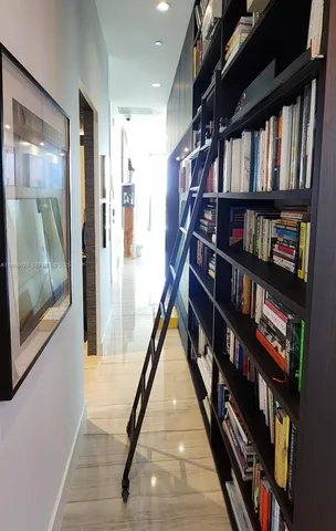 a hallway with a book shelf and a book shelf