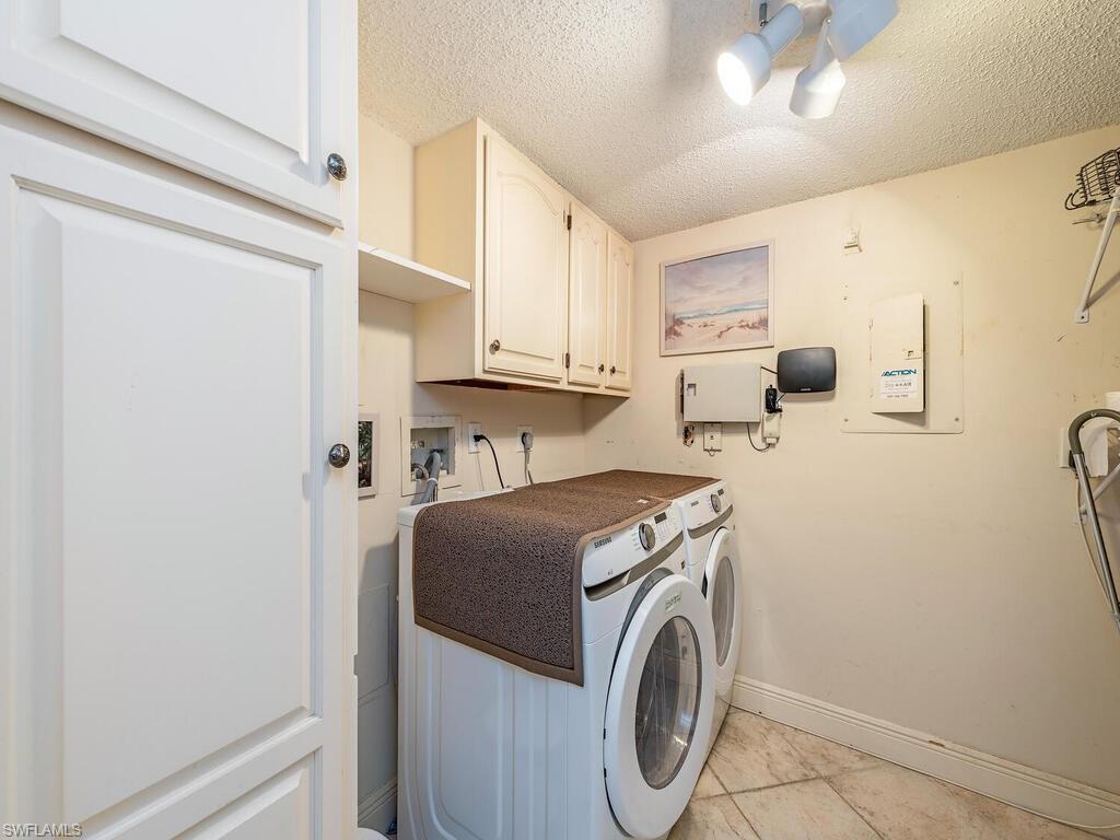 5920 Cranbrook Way, Unit F106 Naples, FL 34112 - Photo 12 of 12 a utility room with dryer and washer