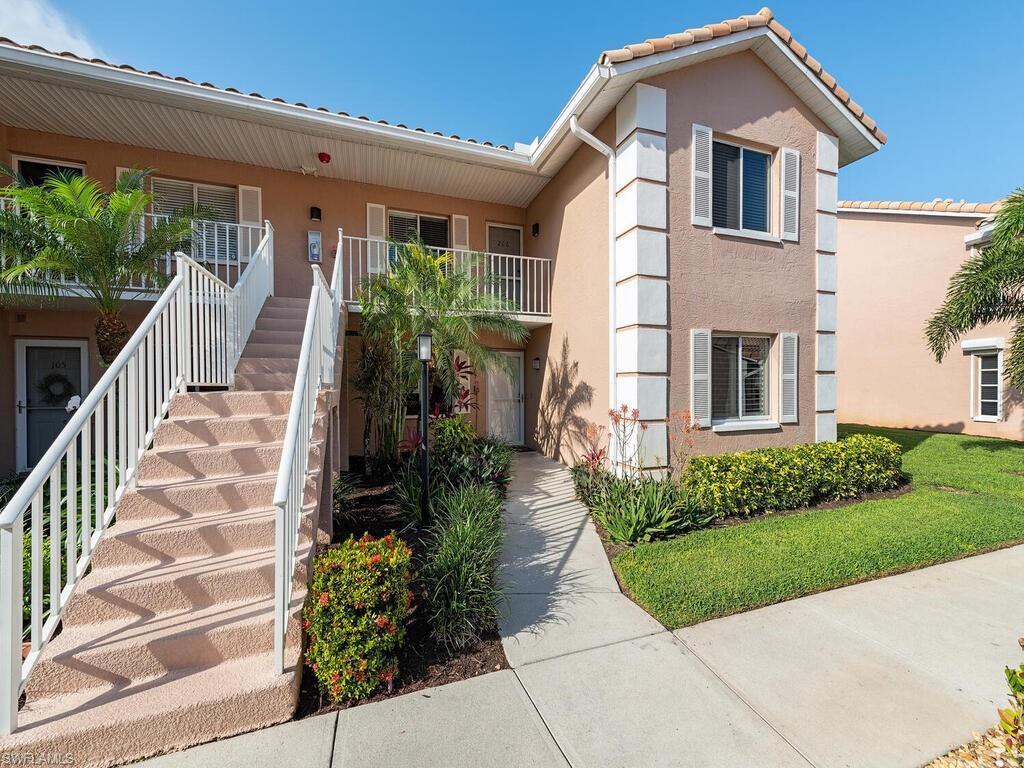 5920 Cranbrook Way, Unit F106 Naples, FL 34112 - Photo 2 of 12 a front view of a house with a yard